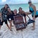 Guests posing with a wooden chest full of loot at a beach on Saint Thomas, US Virgin Islands